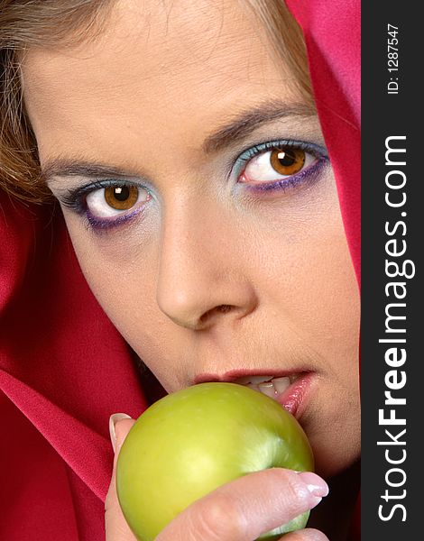 Blond woman in red scarf eating an apple. Blond woman in red scarf eating an apple