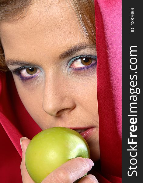 Blond woman in red scarf eating an apple. Blond woman in red scarf eating an apple