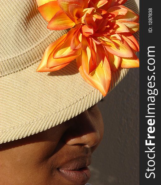African Lady with Hat and Orange Flower. African Lady with Hat and Orange Flower