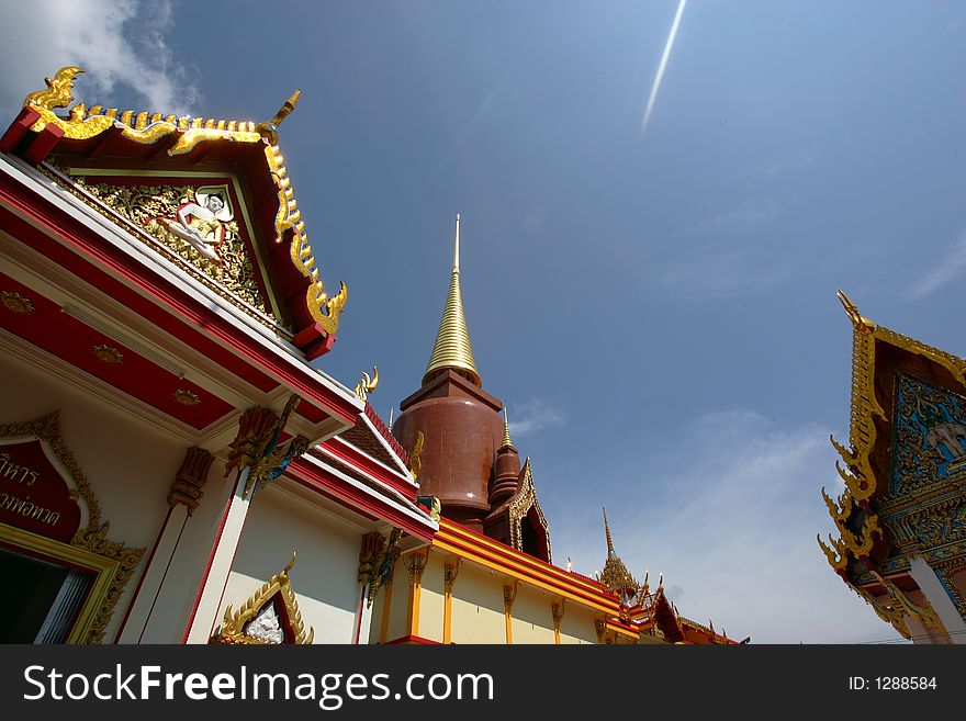A Buddhist temple against a clear blue sky in Thailand. A Buddhist temple against a clear blue sky in Thailand.