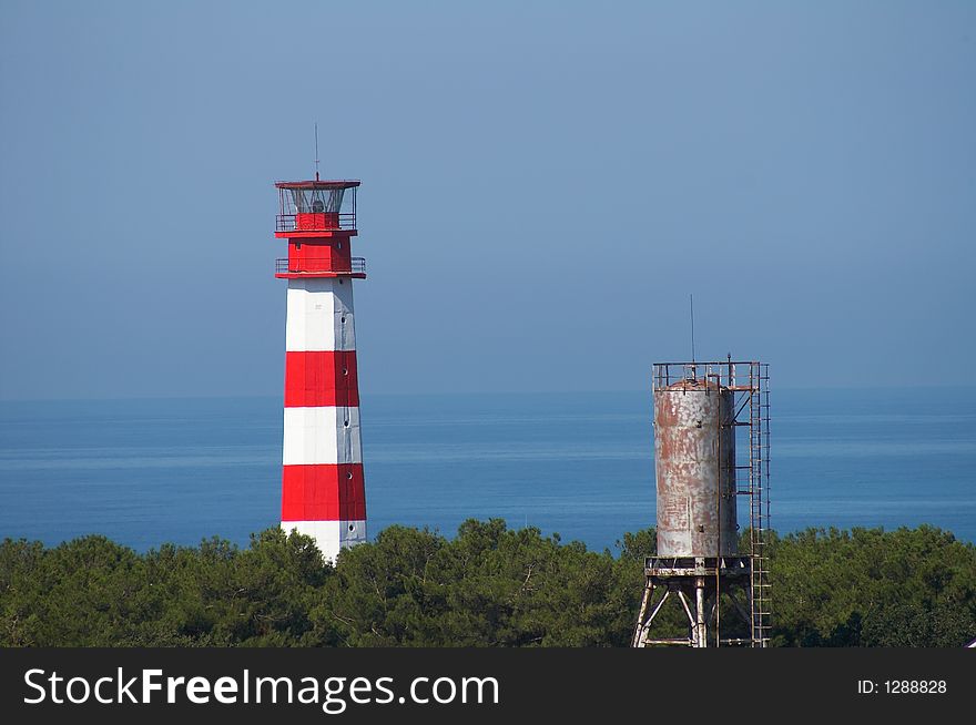 Beacon in a red strip with a water tower in the foreground. Beacon in a red strip with a water tower in the foreground