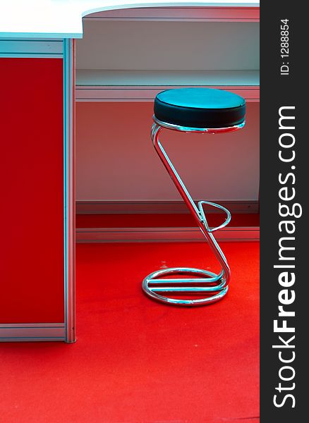 Round metal chair in a red interior