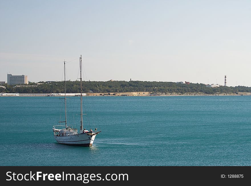 Two-mast sailing vessel on an anchor in harbour. Two-mast sailing vessel on an anchor in harbour