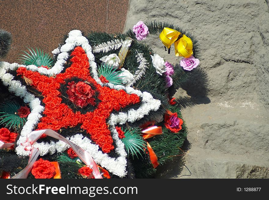 Wreath in the form of a star from red and white flowers. Wreath in the form of a star from red and white flowers