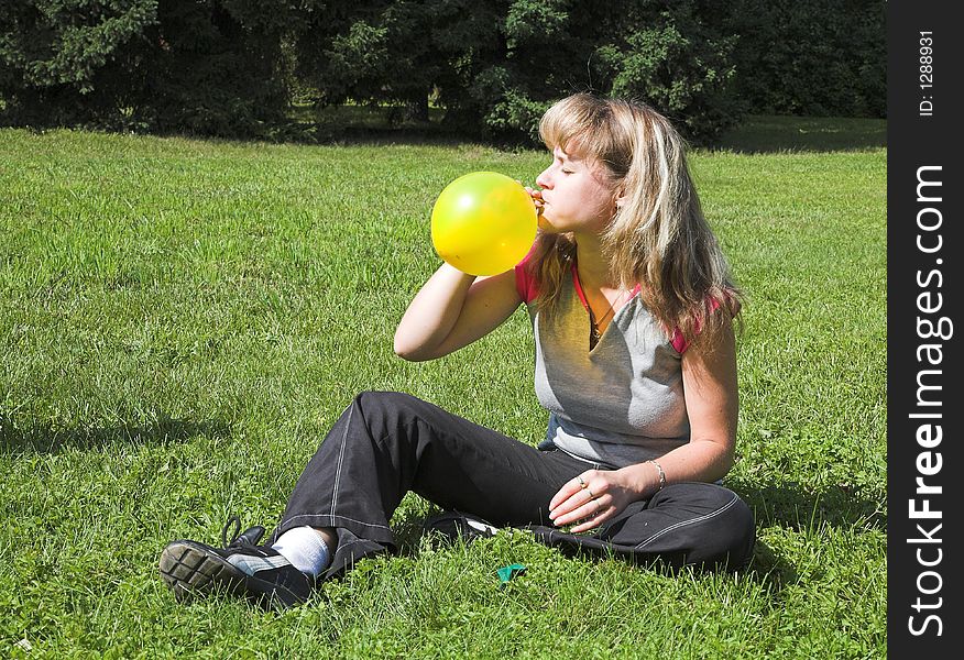 Girl cheats yellow air-ball in  solar daytime. Girl cheats yellow air-ball in  solar daytime