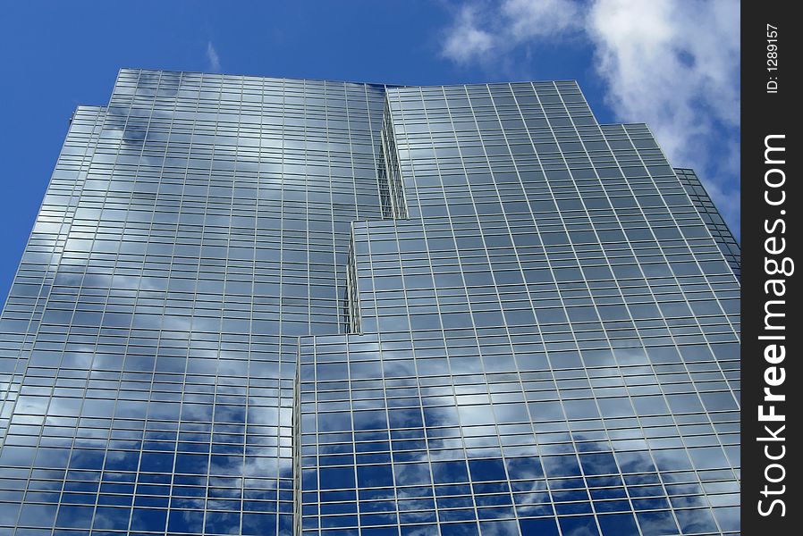 Clouds reflecting in the glass of an office tower. Clouds reflecting in the glass of an office tower.
