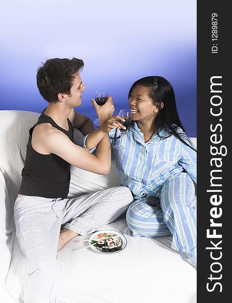 Couple drinking wine over blue background