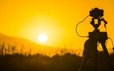 Camera Taking Picture Film Of Sunrise Stock Image