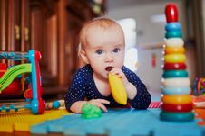 Baby Girl Playing With Toys On The Floor Royalty Free Stock Image