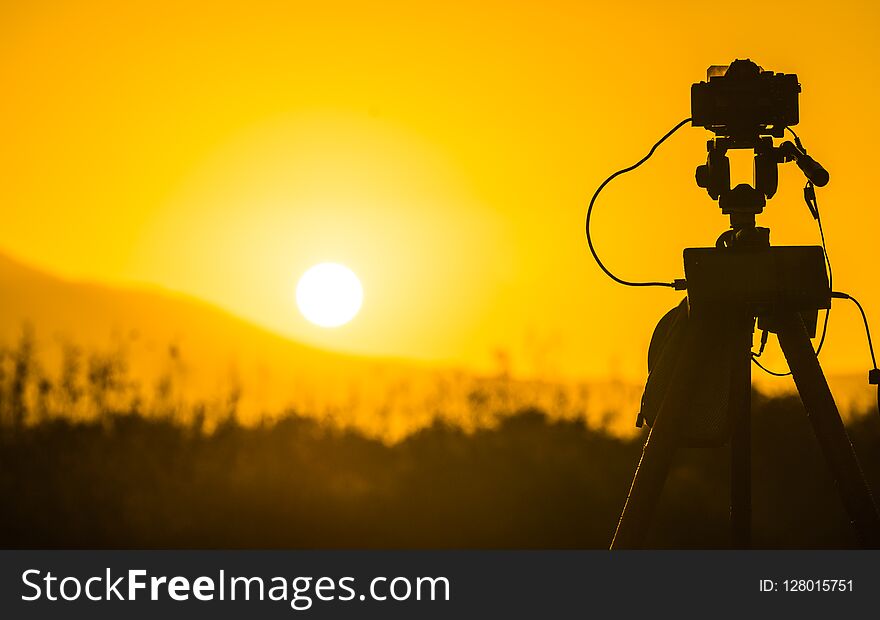 Camera taking picture film of sunrise