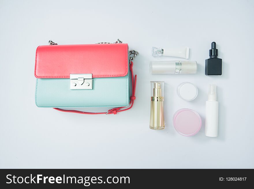 cosmetic product and woman bag isolated on white, cosmetic produ