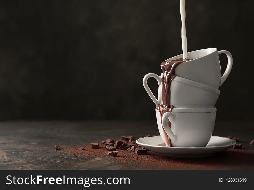 Adding Milk To Tasty Hot Chocolate On Table