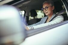 Senior Female Entrepreneur Driving To Office Stock Images
