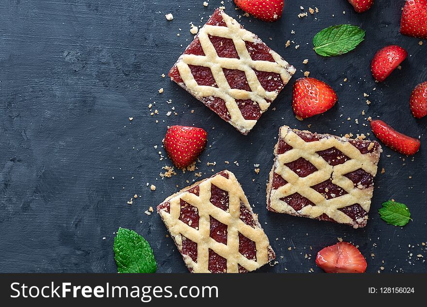 Strawberry cookies with strawberry fruits on dark background.