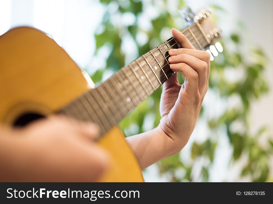 To play the acoustic guitar. Male hand on the deck and the edge