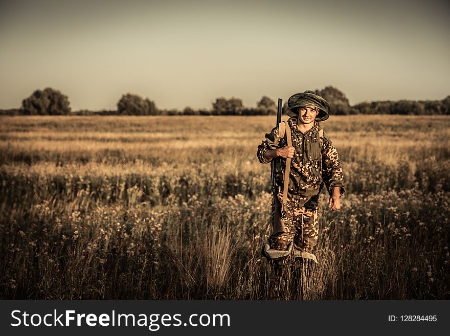 Hunting hunter going rural plain field golden sunset during hunting season vintage