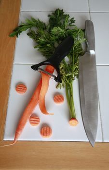 Carrots With Peeler Green Tops Stock Image