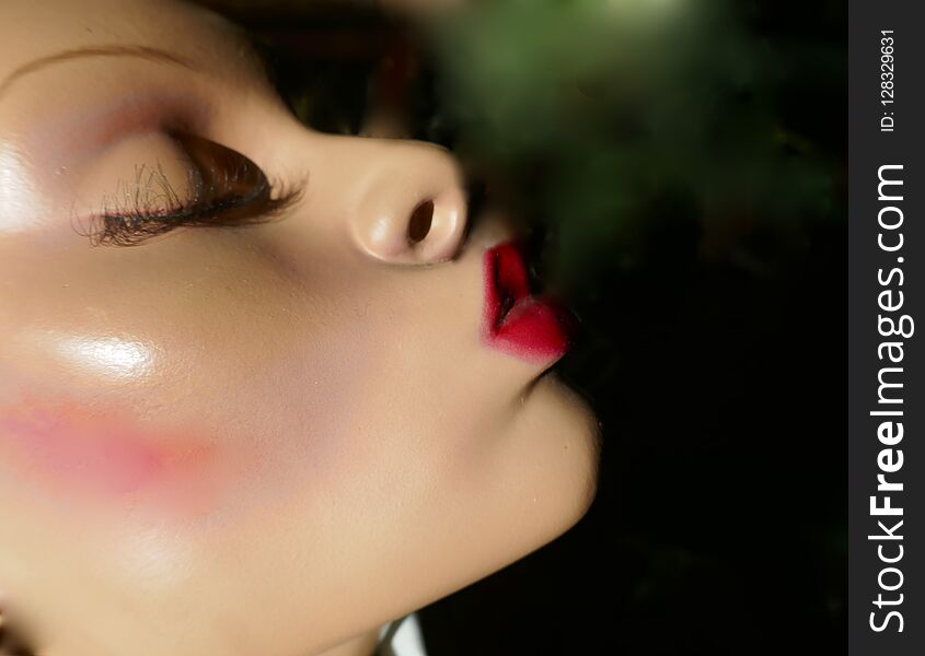 Head of a female mannequin with red kiss mouth
