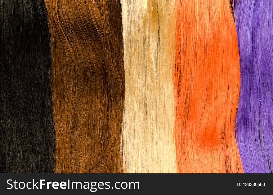 Closeup assorted multicolored hair extensions in blue, brown, blonde, orange, and purple hairs. Useful for salon, shampoo, styling advertisements. Closeup assorted multicolored hair extensions in blue, brown, blonde, orange, and purple hairs. Useful for salon, shampoo, styling advertisements.