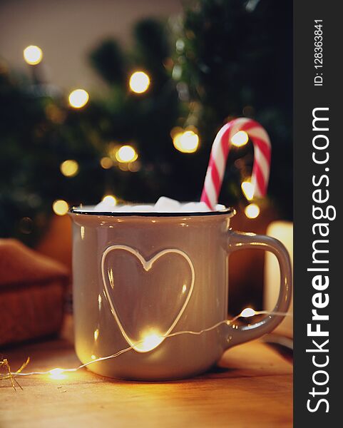 Cocoa mug on a wooden stand. New Year`s picture. Cocoa mug on a wooden stand. New Year`s picture