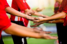 Young Boy Soccer Players Tap Hands Together For Football Training. Stock Photography