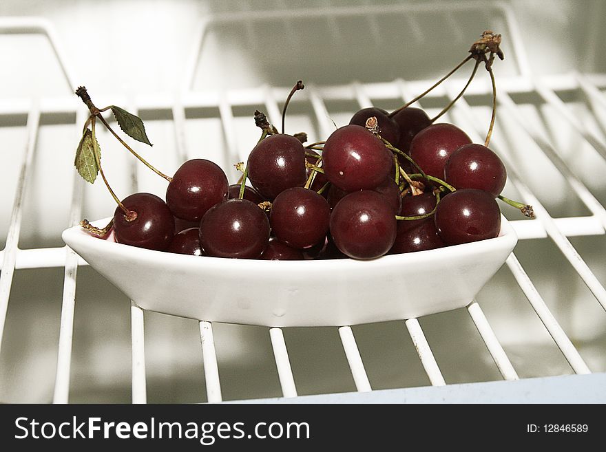 Fresh cherries on shelf of a fridge. Fresh cherries on shelf of a fridge.