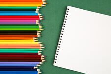 Top View Of A Set Of Many Colorful Pencils And Empty Sketchbook With A Copy Space On A Green Background. Art, Craft, School And Ed Royalty Free Stock Photo