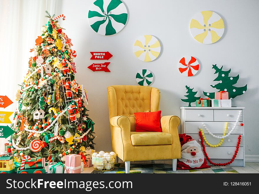 Christmas decorations and a garland on the tree with a home interior. Christmas decorations and a garland on the tree with a home interior