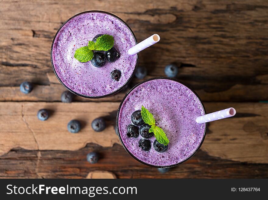 Blueberry smoothies juice,beverage healthy the taste yummy In glass,drink episode morning on white wood from the top view.