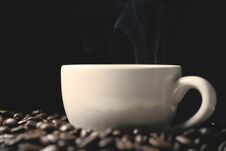 Coffee Beans And Coffee Cup With Smoke Royalty Free Stock Photos