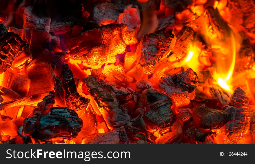 Background of burning hot coals, actively smoldering embers of f