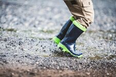 Free Toddler Wearing Rubber Boots In Rainy Weather Stock Photography - 128494332
