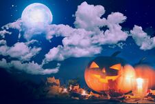 Halloween Pumpkin Jack-o`-lantern On Wooden Table With Candles In A Spooky Night Over Moon And Clouds Stock Photos Halloween Pumpkin Jack-o`-lantern On Wooden Table With Candles In A Spooky Night Over Moon And Clouds Stock Photos