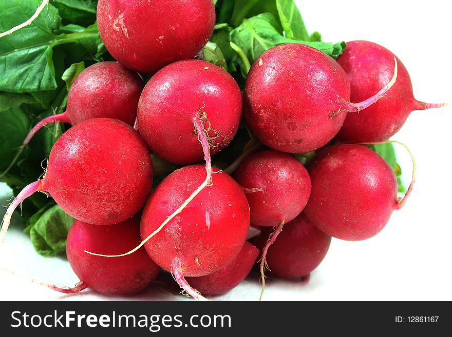 A bunch of radishes on white bord