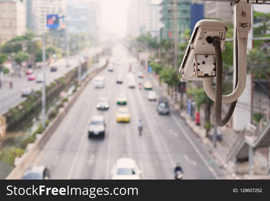 Traffic camera observes vehicular traffic on a road. Surveillance camera