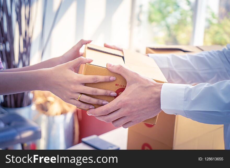 Delivery man is handing packages to a woman