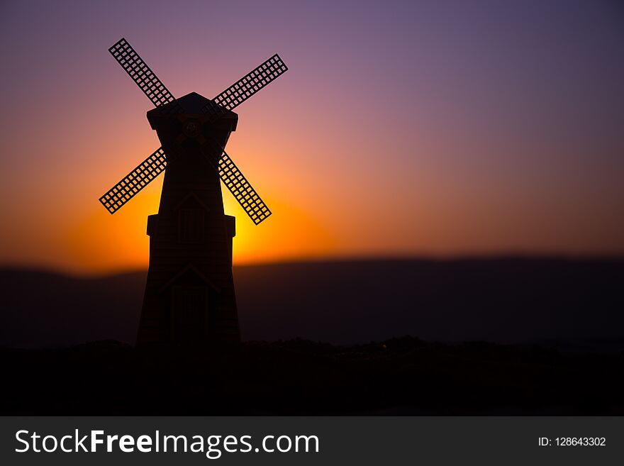 Traditional, Dutch windmill at a hill during a summer sunset. Decoration.