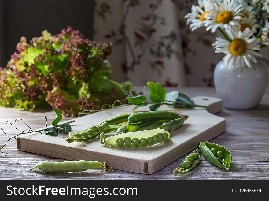 Fresh green peas on a wooden table. Fresh green peas on a wooden table.