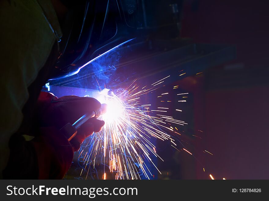 Grinding Machine In Production Polishes The Metal And Sparks Fly Out Of The Abrasive Wheel.