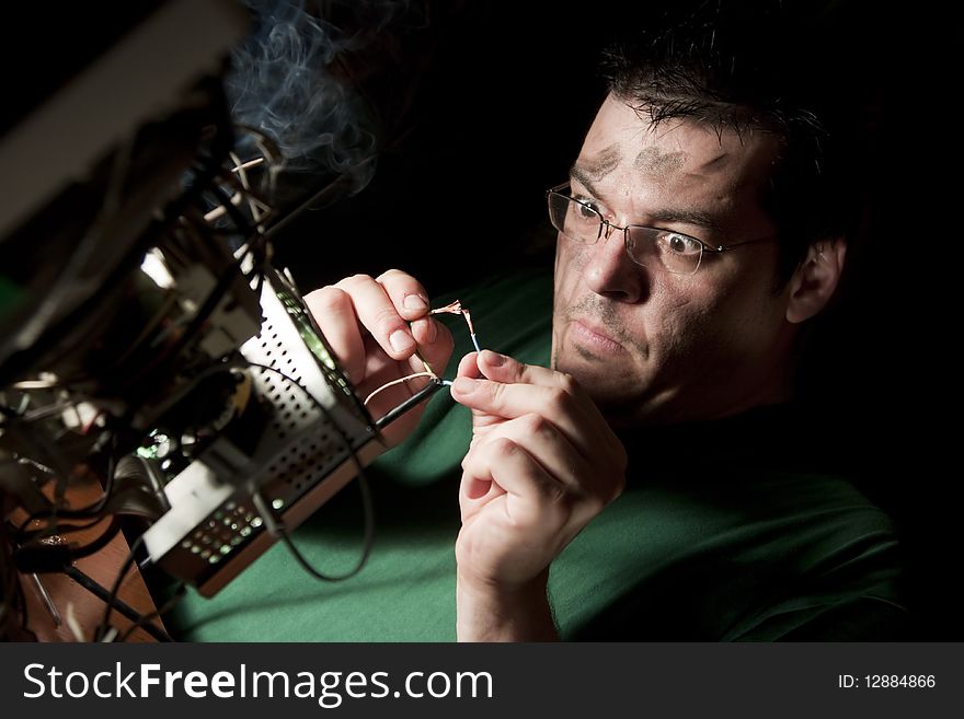 Man repairing computer on fire