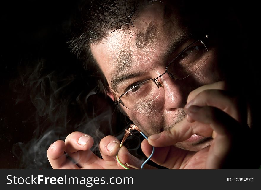 Man repairing old computer on fire