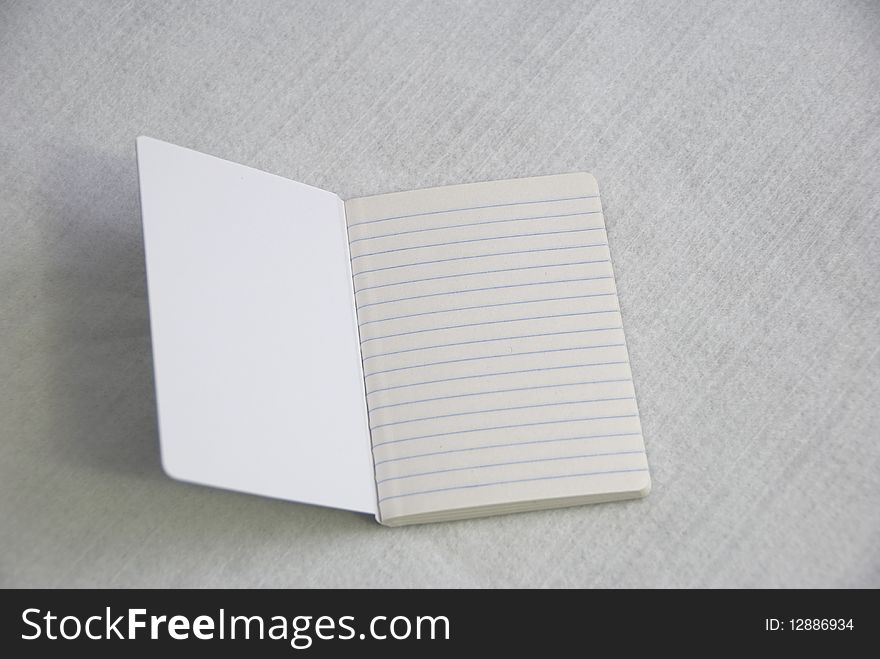 Open notebook with blank ruled pages. Open notebook with blank ruled pages