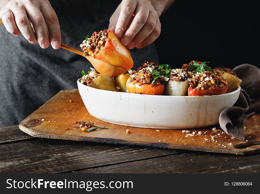 Male hands holding cooked stuffed peppers Healthy vegetarian foo