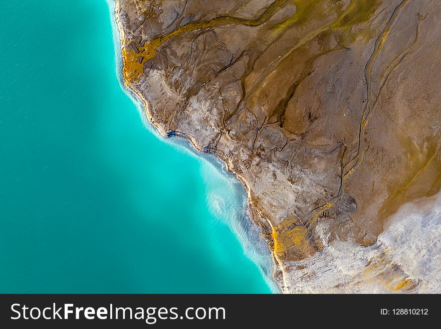 Top down view on rich mineral waste flow from power plant to emerald lake. Top down view on rich mineral waste flow from power plant to emerald lake.