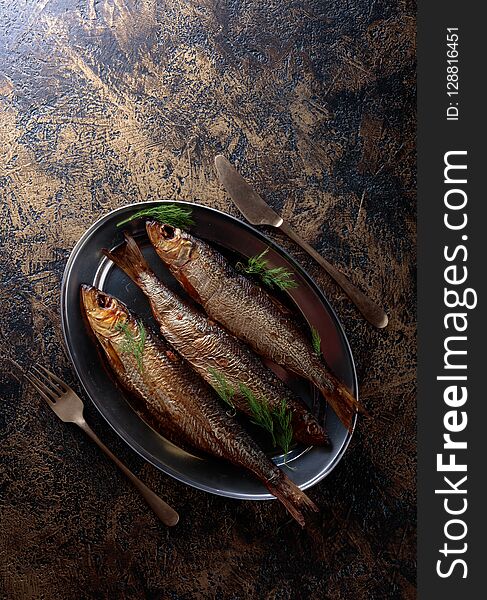 Smoked herring with dill on a metal dish. Copy space for your text. Smoked herring with dill on a metal dish. Copy space for your text.