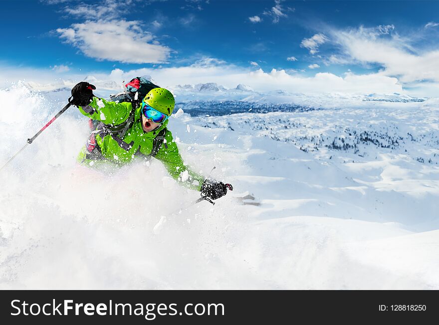 Alpine freeride skier skiing downhill with powder snow explosion. Winter sports and leasure activities. Alpine freeride skier skiing downhill with powder snow explosion. Winter sports and leasure activities