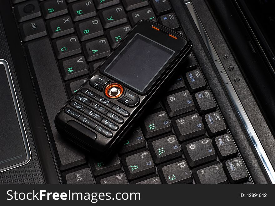 Mobile Phone On A Laptop