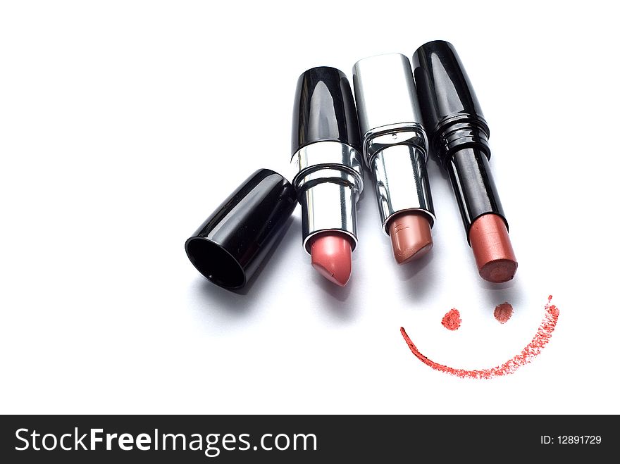 Three lipsticks and smile on a white background. Three lipsticks and smile on a white background