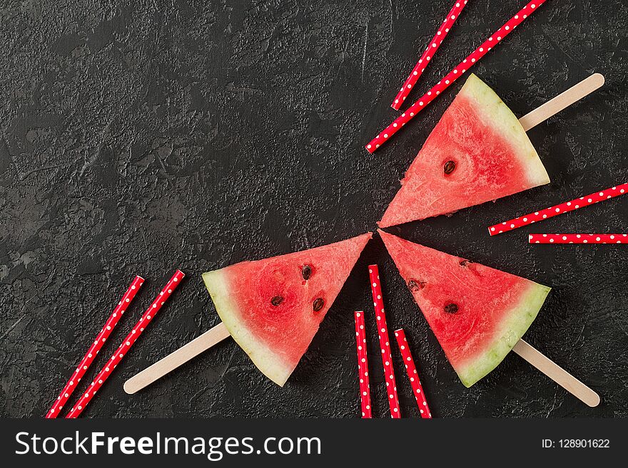 Fresh watermelon cut into pieces on dark background