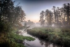River In The Fog, Just Before Sunrise. A Warm Glow In The Clouds From The First Rays Of The Sun. Royalty Free Stock Photos River In The Fog, Just Before Sunrise. A Warm Glow In The Clouds From The First Rays Of The Sun. Royalty Free Stock Photos